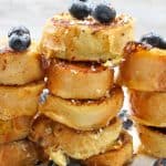 This Coconut French Toast is made with thick, dense bread, crusted with coconut, smothered in fruit, and drizzled with honey.