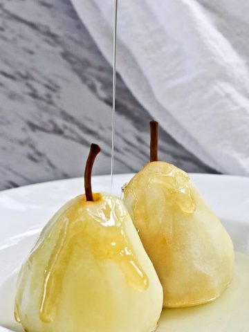 These Poached Pears with Cardamom are a light and delicious dessert of pears poached in a spiced white wine.
