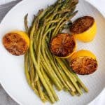 This Oven-Roasted Asparagus with Charred Lemon is drizzled in olive oil, golden balsamic vinegar, lemon slices, and seasoning. It's fast, easy, and delicious!