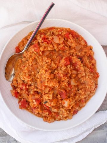 Red lentil dal in a white serving dish