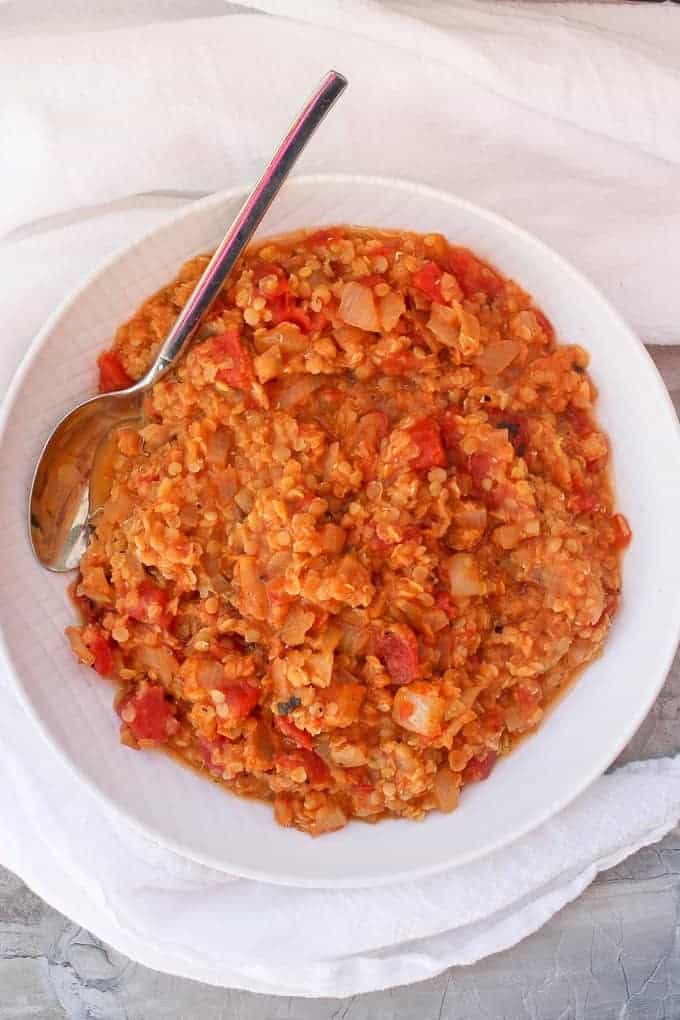 Red lentil dal in a white serving dish