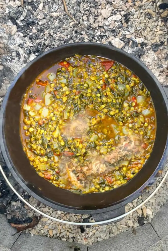 campfire fish lentil stew in a Dutch oven