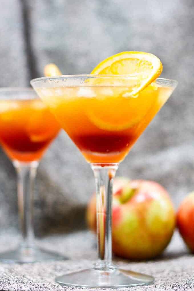 Apple Cider Kentucky Sunrise in a Martini Glass with an Orange on the Rim