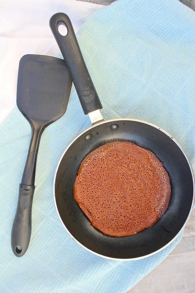 Chocolate Crepe in a Nonstick Pan with a Plastic Spatula