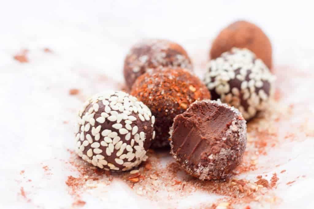 chocolate truffles with sesame seed, chili flake, and sugar coating.