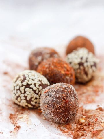 Chocolate truffles with sugar, sesame seed, and chili flake coating