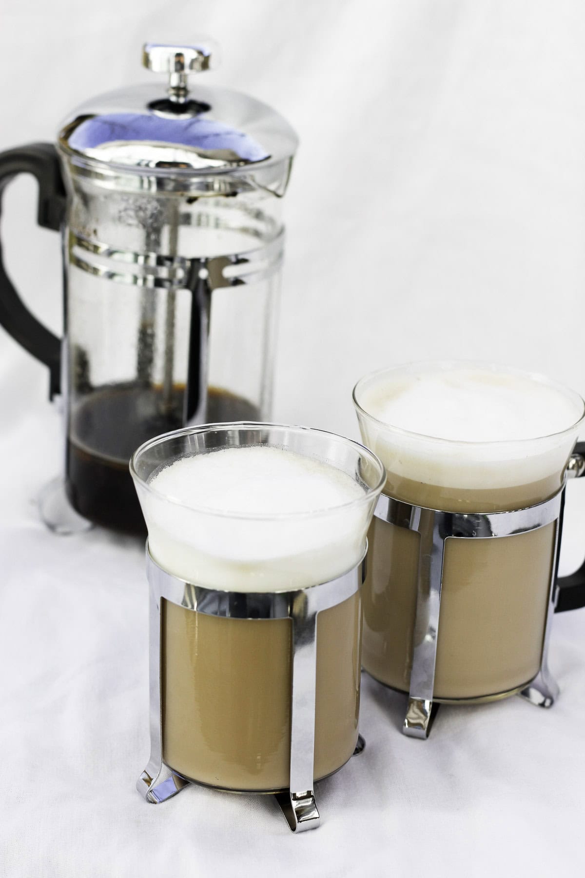 french press cappuccinos in glasses.