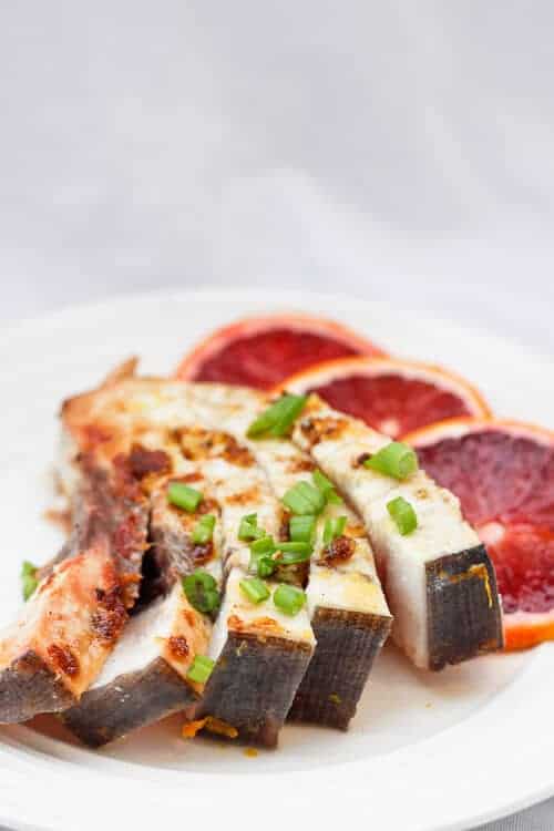 Pan-Seared Swordfish on a plate with blood orange slices