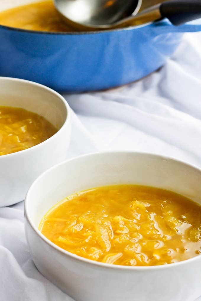 garlic get well soup in bowls and a soup pot
