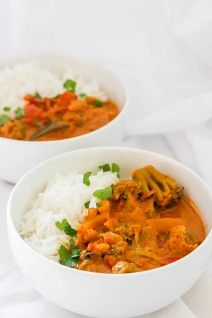 vegetable tikka masala in bowls with rice.