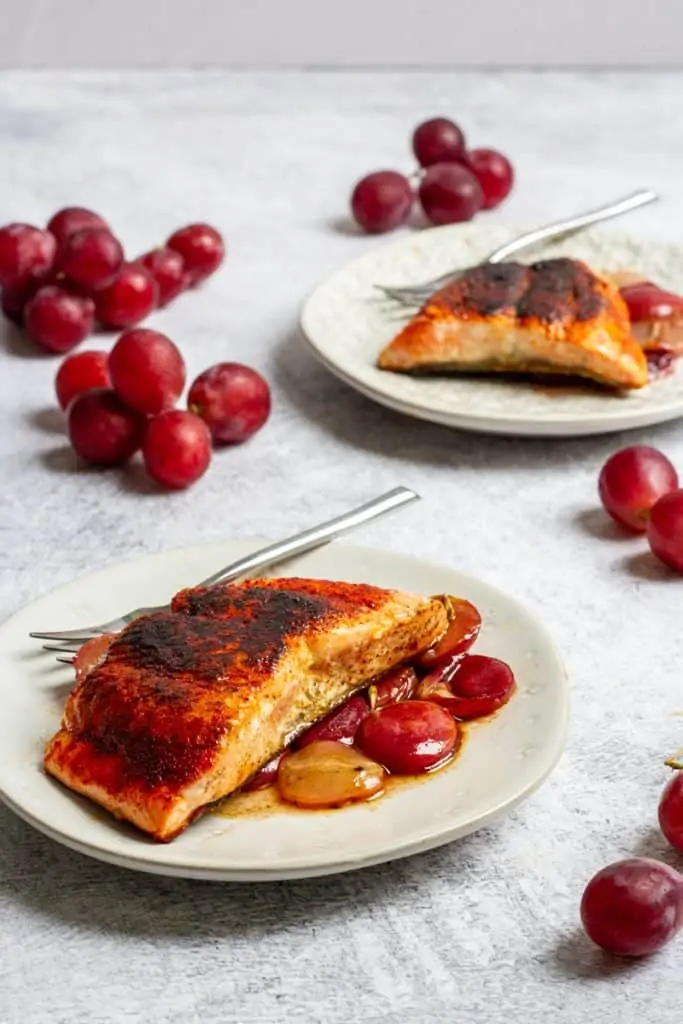smoked paprika salmon on plates with rosemary grapes
