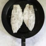 fish fillets in hot pan.