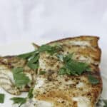 pan-seared barramundi on plate.