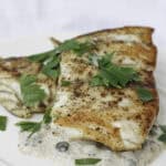 pan-seared barramundi on plate.