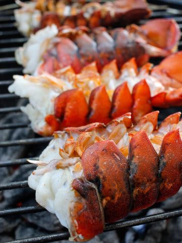 This grilling season, bring out the lobster! These incredibly easy Grilled Bourbon Lobster Tails are grilled to perfection and coated with a bourbon butter sauce.