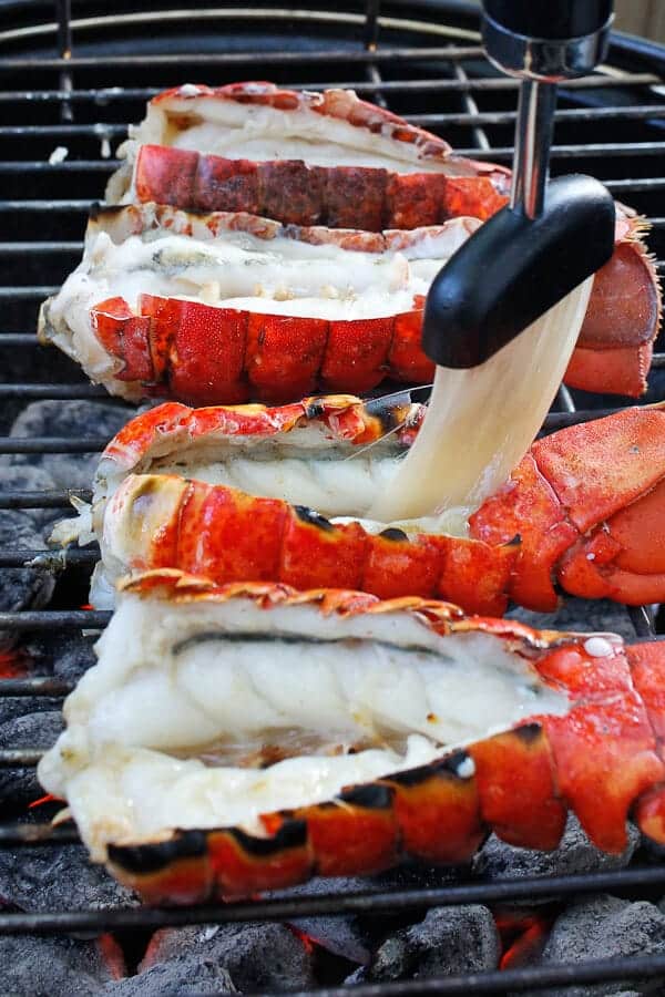 Brushing Butter on Lobster Tails while they Grill