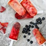 These easy two-ingredient Kombucha Popsicles are the perfect cool treat on a hot summer day! champagne-tastes.com