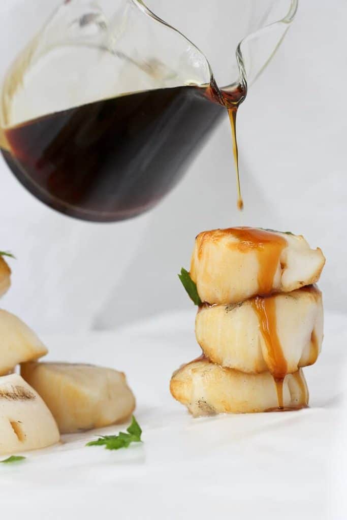 Pouring Bourbon Sauce on Grilled Scallops