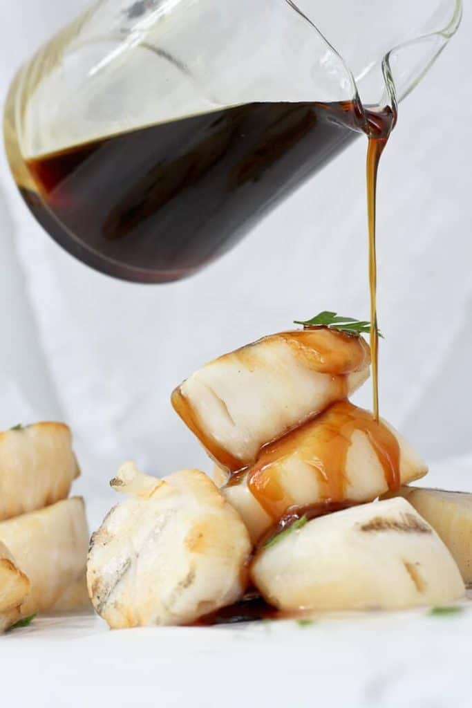 Pouring Bourbon Sauce on Grilled Scallops.