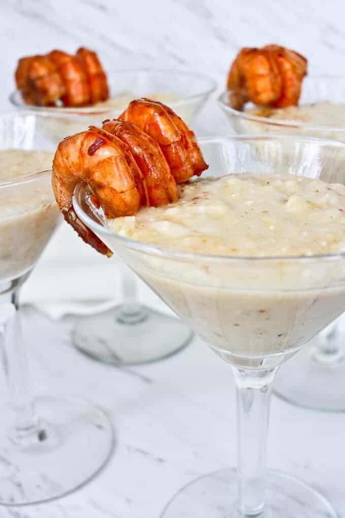 Cajun Shrimp and Grits Served in Cocktail Glasses with the Shrimp on the Glass Rim