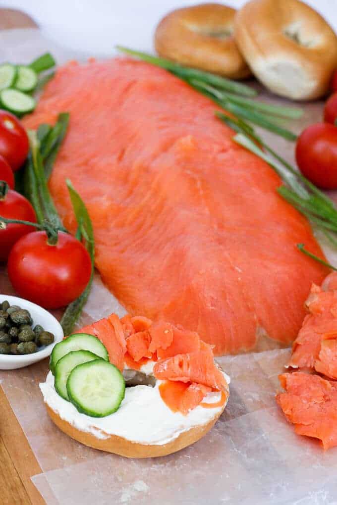 Bagels and Lox arranged on a Serving Platter with Tomatoes, Cucumbers, Capers, and Cream Cheese