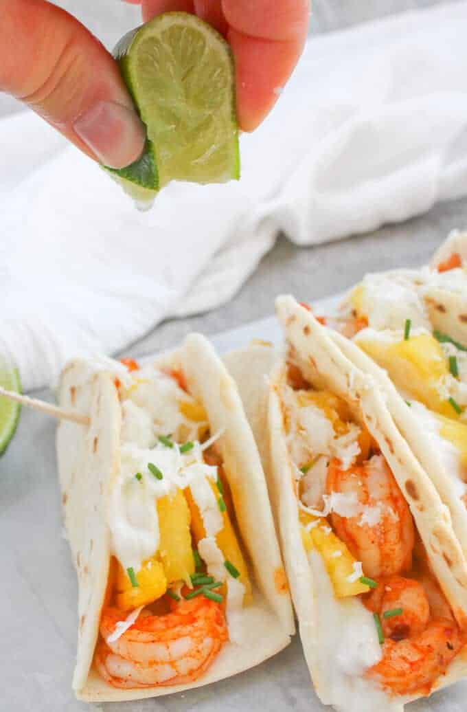 Squeezing lime juice onto Pineapple Shrimp Tacos.