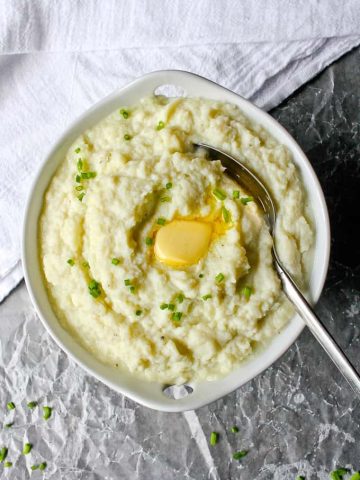 instant pot mashed cauliflower in a serving bowl