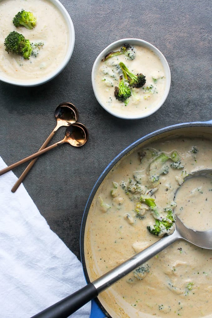 cauliflower broccoli soup in a dutch oven and bowls