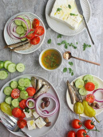 Greek salad without lettuce arranged onto plates