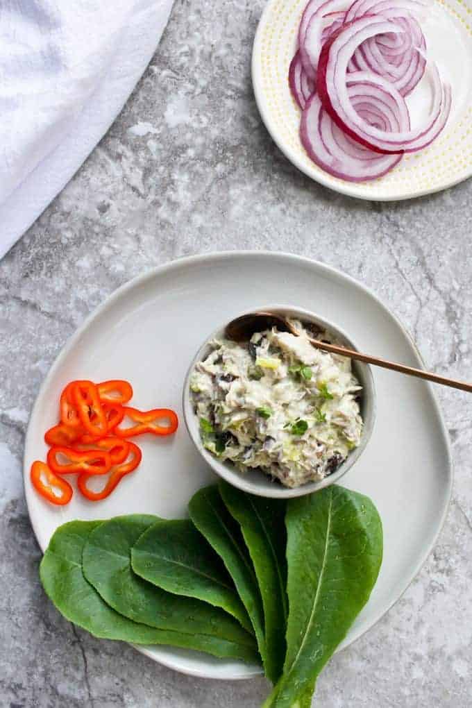 mackerel salad on a plate with lettuce and veggies.