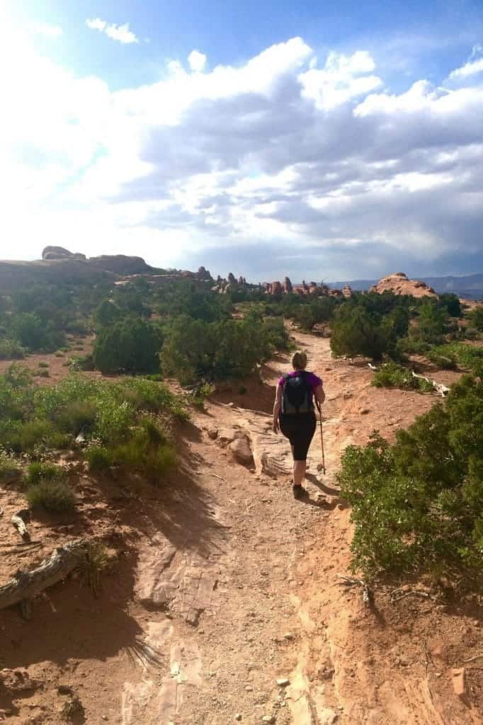 Woman hiking on Devil's Garden Trail and wearing women's hiking shoes.