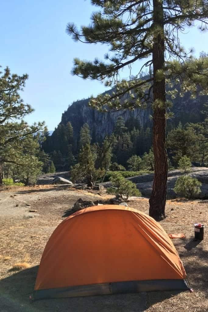 Orange backpacking tent at campsite while backpacking in Yosemite.