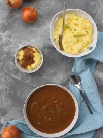 vegan onion gravy in a serving dish with mashed potatoes