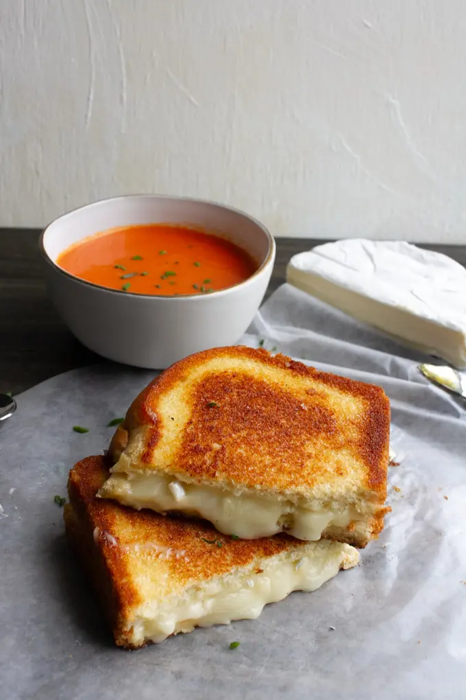 brie grilled cheese and a bowl of tomato soup