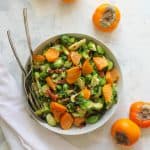 roasted brussels sprouts salad with persimmon in a serving dish