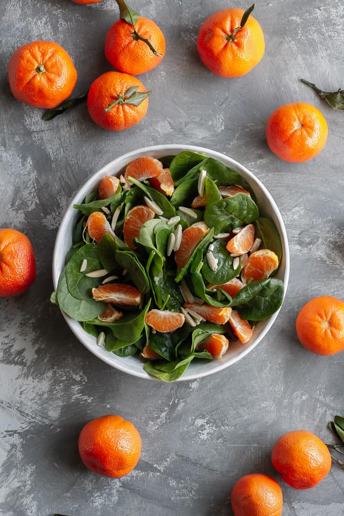 spinach mandarin orange salad in a serving dish