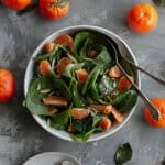 This vegan spinach mandarin orange salad is served with almond slivers and tossed in a quick Dijon vinaigrette for an easy spring side dish.