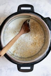 Add rice, 1 cup milk, syrup, + salt to Instant Pot
