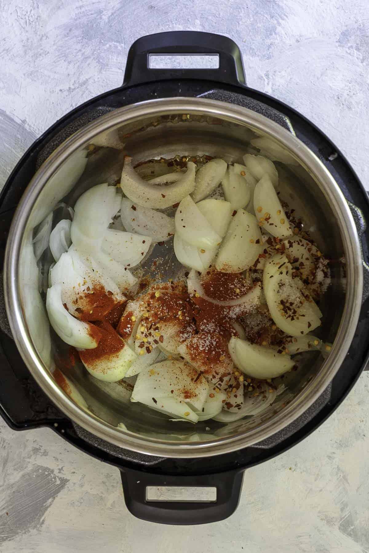 onions and seasoning in instant pot.