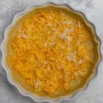 Add half the cheese to the pie crust