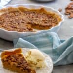 This easy pumpkin pecan pie is a perfect blend of two fall desserts. It's made with maple syrup, a splash of bourbon (or whiskey), and is easy to make ahead and freeze for later!