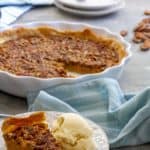 This easy pumpkin pecan pie is a perfect blend of two fall desserts. It's made with maple syrup, a splash of bourbon (or whiskey), and is easy to make ahead and freeze for later!