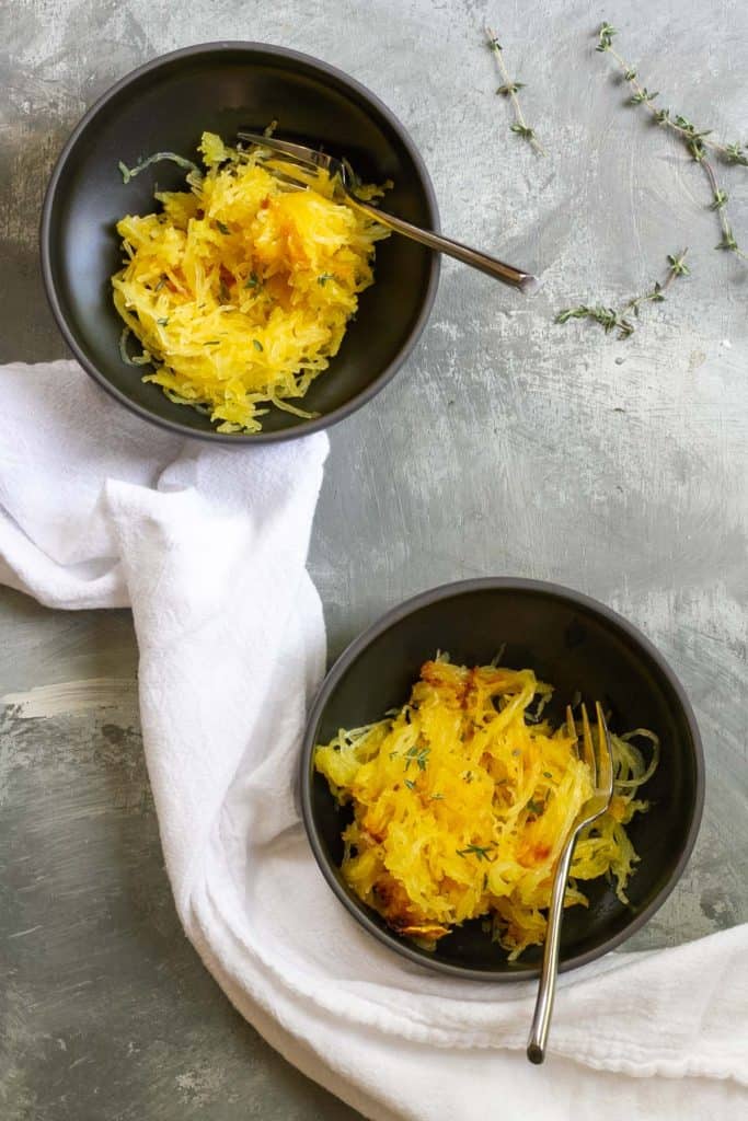 Roasted spaghetti squash in serving dishes.