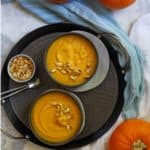 This vegan pumpkin soup is made with pumpkin purée (homemade or canned), cauliflower, coconut milk, and spices. Make it in an Instant Pot® or use your oven!