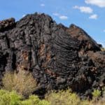 The Valley of Fires in Carrizozo, New Mexico is one of the youngest lava flows in the continental United States. Visit this park to explore the hardened lava fields!