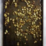 crispy seasoned potatoes on a baking sheet.