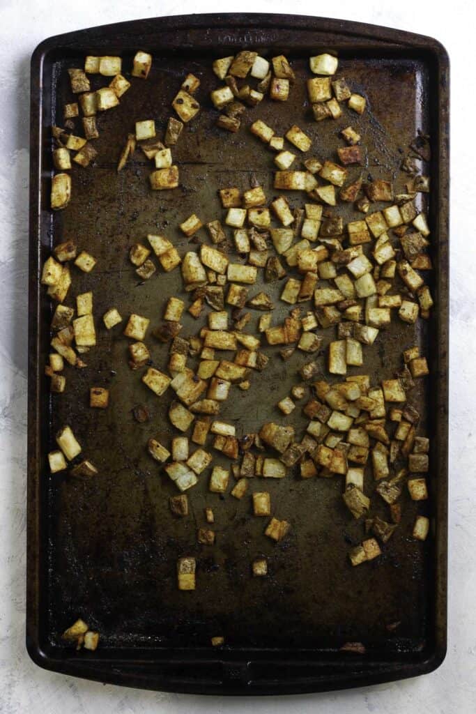 crispy seasoned potatoes on a baking sheet.