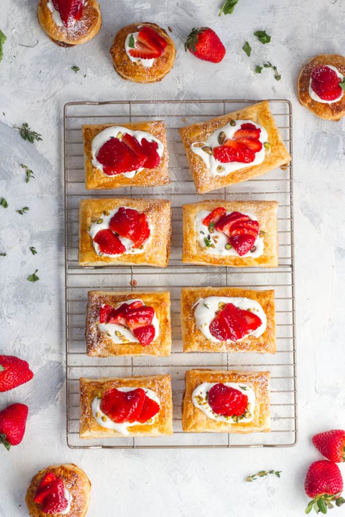 These easy strawberry tarts are the perfect spring dessert, and are made with puff pastry, mascarpone whipped cream, and glazed fresh strawberries.
