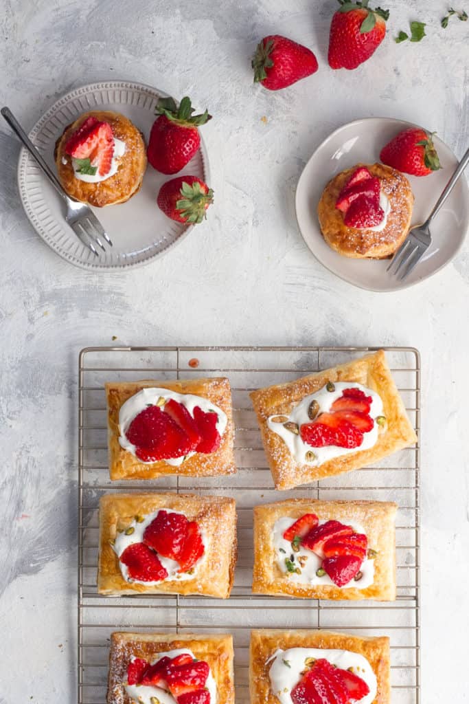 These easy strawberry tarts are the perfect spring dessert, and are made with puff pastry, mascarpone whipped cream, and glazed fresh strawberries.