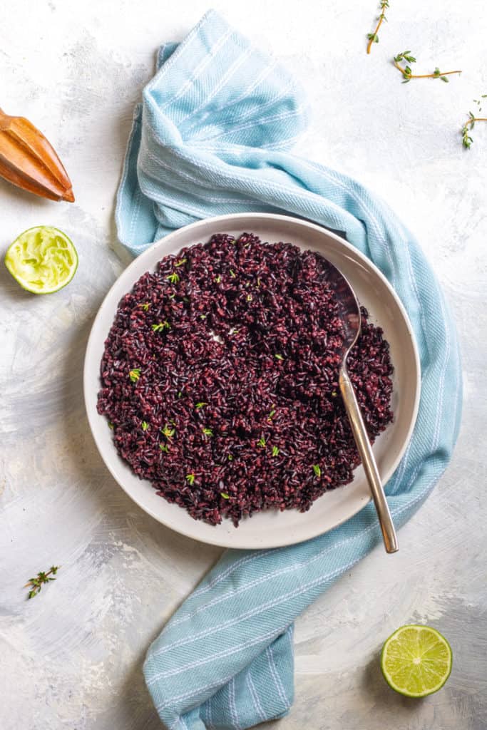 Black rice with lime dressing in a serving dish.